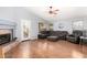 Inviting living room with vaulted ceilings, fireplace, and comfortable sectional couch on wood floors at 15328 W Memory Ln, Surprise, AZ 85374