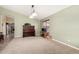 Spacious living room with neutral carpet, light green walls, a piano, and ample natural light at 15328 W Memory Ln, Surprise, AZ 85374