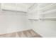 Walk-in closet with ample shelving, metal racks, and carpet flooring at 15328 W Memory Ln, Surprise, AZ 85374