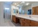 Bright bathroom with double sinks, a large mirror, and a glass shower at 1539 E Brenda Dr, Casa Grande, AZ 85122