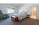Comfortable bedroom featuring a decorative quilt, window, and wooden desk at 1539 E Brenda Dr, Casa Grande, AZ 85122