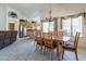 Dining area with a modern chandelier, wooden dining table, and chairs, adjacent to the kitchen at 1539 E Brenda Dr, Casa Grande, AZ 85122