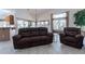 Inviting living room featuring tile floors, and a comfortable recliner sofa with a view to an outdoor area at 1539 E Brenda Dr, Casa Grande, AZ 85122