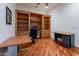 Spacious office featuring hardwood floors, built-in shelves, and multiple desks at 1539 E Brenda Dr, Casa Grande, AZ 85122