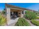 Charming covered patio with outdoor seating and lush landscaping at 1539 E Brenda Dr, Casa Grande, AZ 85122