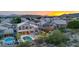 Wide aerial shot of beautiful backyard with pool, firepit, spa, outdoor kitchen and colorful sunset at 15413 S 31St Pl, Phoenix, AZ 85048