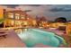 Luxury backyard featuring a sparkling pool, spa, and outdoor living areas with a stunning sunset view at 15413 S 31St Pl, Phoenix, AZ 85048