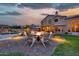 Luxurious backyard with a pool, patio area, firepit, grassy space, mountain views, and outdoor lighting at 15413 S 31St Pl, Phoenix, AZ 85048