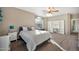 Bright bedroom with plush carpeting, a ceiling fan, and large window creating a warm atmosphere at 15413 S 31St Pl, Phoenix, AZ 85048