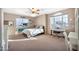 Inviting bedroom featuring large windows, a ceiling fan, and neutral decor, perfect for relaxing at 15413 S 31St Pl, Phoenix, AZ 85048