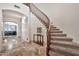 Grand entryway boasting a curved staircase, stone floors, and elegant decor at 15413 S 31St Pl, Phoenix, AZ 85048