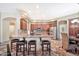 This spacious open kitchen has granite countertops, stainless steel appliances, an island and seating at 15413 S 31St Pl, Phoenix, AZ 85048