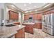 Modern kitchen features granite countertops, stainless steel appliances, an island and wood cabinets at 15413 S 31St Pl, Phoenix, AZ 85048