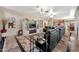 This open living room has a wall of windows, stone floors, leather seating, entertainment center and fireplace at 15413 S 31St Pl, Phoenix, AZ 85048