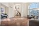 Elegant living room with hardwood floors, staircase, chandelier, and bright natural light at 15413 S 31St Pl, Phoenix, AZ 85048