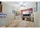 Spacious home office with tiled floors, built-in shelving, and a ceiling fan at 15413 S 31St Pl, Phoenix, AZ 85048