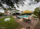 Expansive backyard with a pool, spa, and a large patio, ideal for outdoor entertaining and leisure at 15418 W Surrey Dr, Surprise, AZ 85379