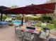 Spacious backyard with a patio, BBQ, outdoor dining area, and a pool, perfect for entertaining guests at 15418 W Surrey Dr, Surprise, AZ 85379