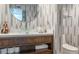 Modern bathroom with sleek vanity, glass bowl sink, and designer wallpaper at 1621 E Maryland Ave, Phoenix, AZ 85016
