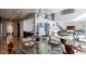 Open-concept view of a dining room showcases a glass-top table, inviting a blend of casual elegance at 1621 E Maryland Ave, Phoenix, AZ 85016