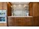 Modern kitchen with stainless steel appliances, custom cabinetry, and stylish backsplash at 1621 E Maryland Ave, Phoenix, AZ 85016