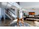 Open-concept living room featuring hardwood floors, stairs, modern decor and a large window at 1621 E Maryland Ave, Phoenix, AZ 85016