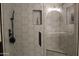 Modern shower with white hexagon tile, black hardware, glass door and built-in niche at 1621 E Maryland Ave, Phoenix, AZ 85016