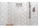 Modern shower design with white hexagonal tiles, features a built-in niche and sleek showerhead at 1621 E Maryland Ave, Phoenix, AZ 85016