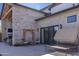 Relaxing back patio featuring a brick exterior, a seating area, outdoor fireplace, and tanning chaise lounge at 16322 E Fairview St, Gilbert, AZ 85295