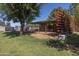 Open horse paddock and pen area in a large grassy backyard with mature trees for shade at 16322 E Fairview St, Gilbert, AZ 85295