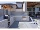 Outdoor kitchen and lounge area with grill and pizza oven at 16322 E Fairview St, Gilbert, AZ 85295