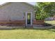 Expansive brick home with a backyard featuring a wooden fence, lush green grass, and mature shade trees at 16322 E Fairview St, Gilbert, AZ 85295