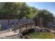 Tranquil backyard featuring a wooden bridge, koi pond, rock features, and mature landscape at 16322 E Fairview St, Gilbert, AZ 85295