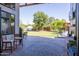 Expansive backyard featuring a deck, lush lawn, and mature trees, offering a serene outdoor space at 16322 E Fairview St, Gilbert, AZ 85295
