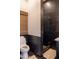 Contemporary bathroom with a black marble-tiled shower and a toilet, offering a sleek and modern design at 16322 E Fairview St, Gilbert, AZ 85295