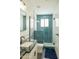 Modern bathroom featuring blue tiled shower, sleek black fixtures, and stylish tile accents, creating a spa-like retreat at 16322 E Fairview St, Gilbert, AZ 85295
