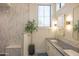 Bright bathroom featuring double sinks, stylish fixtures, and a glass-enclosed shower at 16322 E Fairview St, Gilbert, AZ 85295