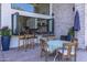 Outdoor covered seating area with view to kitchen through open windows at 16322 E Fairview St, Gilbert, AZ 85295