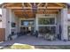 Beautiful outdoor living area with brick fireplace, mounted TV and ceiling fans at 16322 E Fairview St, Gilbert, AZ 85295