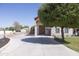 Wide driveway leading to a home with a stone facade, wooden accents, and professional landscaping at 16322 E Fairview St, Gilbert, AZ 85295