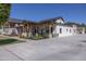 Expansive home showcasing a covered patio, manicured landscaping, water feature and ample parking space at 16322 E Fairview St, Gilbert, AZ 85295