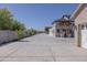 Spacious driveway leading to the inviting entrance with a stone-accented facade and modern lighting at 16322 E Fairview St, Gilbert, AZ 85295