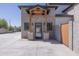 Beautiful brick building entrance featuring a covered entryway with wood accents and concrete driveway at 16322 E Fairview St, Gilbert, AZ 85295