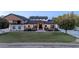 Beautiful home showcasing a manicured lawn, inviting porch, and elegant stone and wood accents at 16322 E Fairview St, Gilbert, AZ 85295
