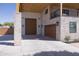 Spacious three-car garage featuring paneled doors, stone accents, and ample driveway space at 16322 E Fairview St, Gilbert, AZ 85295