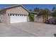 Spacious two-car garage with white doors and brick exterior, offering ample parking and storage space at 16322 E Fairview St, Gilbert, AZ 85295