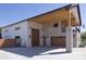 Exterior angle showcasing spacious garage, brick accents, and charming upper balcony at 16322 E Fairview St, Gilbert, AZ 85295