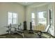 Bright home gym with ample natural light, multiple exercise machines, and a dedicated space for fitness activities at 16322 E Fairview St, Gilbert, AZ 85295