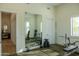 Well-equipped home gym featuring weights, machines, and a large mirror, perfect for a complete workout at 16322 E Fairview St, Gilbert, AZ 85295