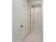 Hallway with custom, white, built in cabinets, white doors, black hardware and marble floors at 16322 E Fairview St, Gilbert, AZ 85295